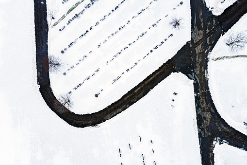 Looking down on a cemetery covered with fresh snow.