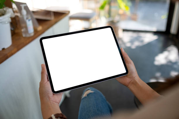 istock a woman holding digital tablet with blank white desktop screen 1294748924