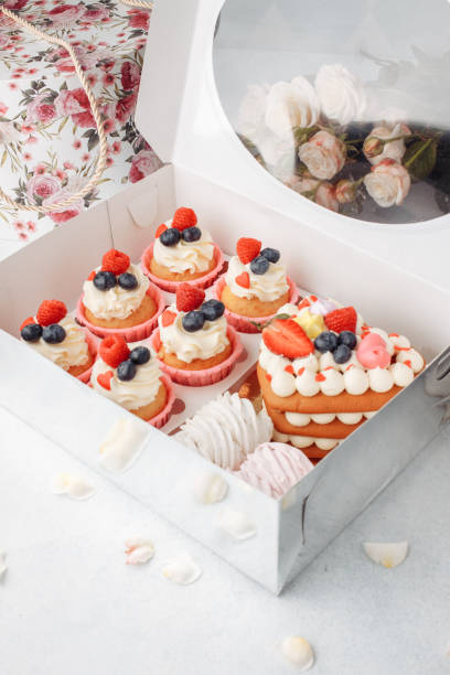 istock Preparing care package, seasonal gift box with cape cake and roses. Personalized eco friendly basket for holidays. Concept valentine day. Top view, flat lay 1294750269