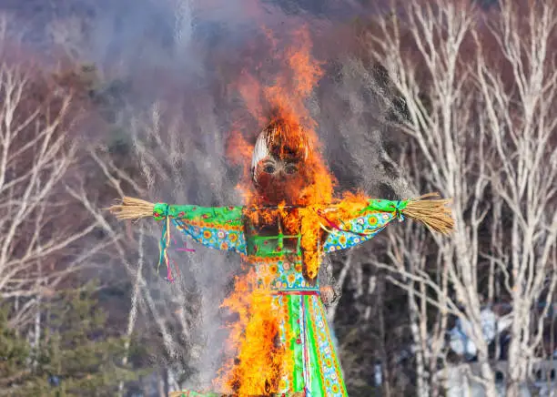 Celebration of Maslenitsa, traditional Russian non-official holiday dedicated to the approach of spring (Eastern Slavic celebration Shrovetide) - burning effigy made from straw.