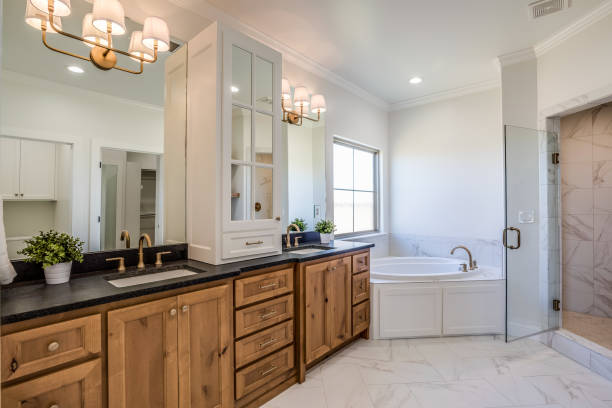 istock Master bathroom with natural wood and dark countertops 1294767034