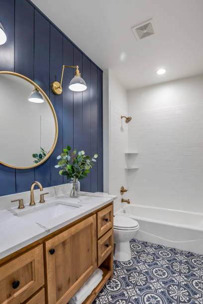 Natural wood vanity in new bathroom Blue shiplap walls with round mirror and sconce lights home addition photos stock pictures, royalty-free photos & images
