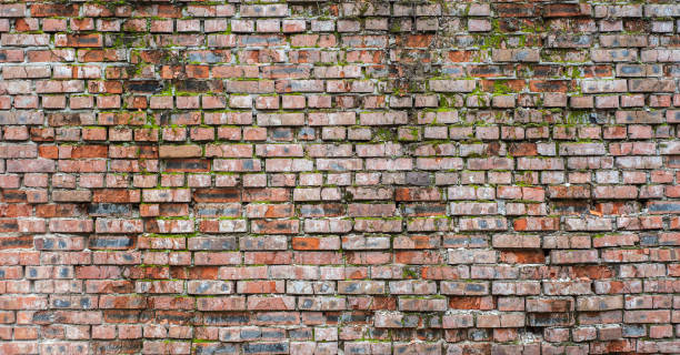 Old brick wall with moss and concrete Old red brick wall with moss and concrete old stone wall stock pictures, royalty-free photos & images