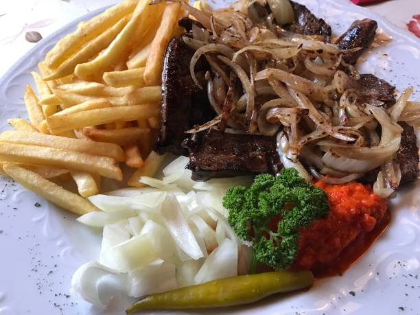 meat fried in olive oil and butter with fries onions paprika parsley ayvar