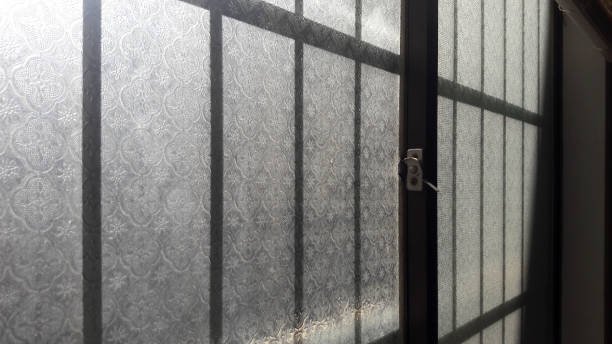 istock Patterned old glass windows, the morning sun shines in 1294774046