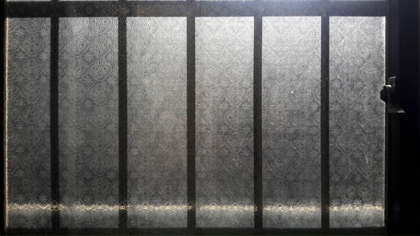 istock Patterned old glass windows, the morning sun shines in 1294774713