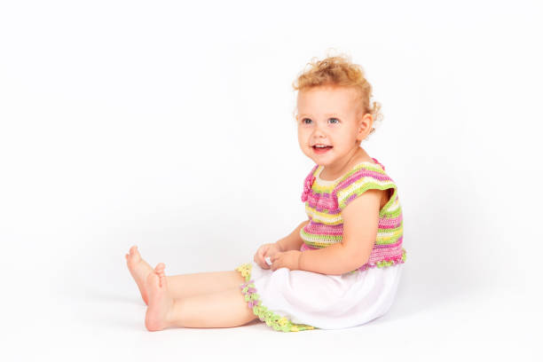 little girl with curly hair playing at home, isolate on white background