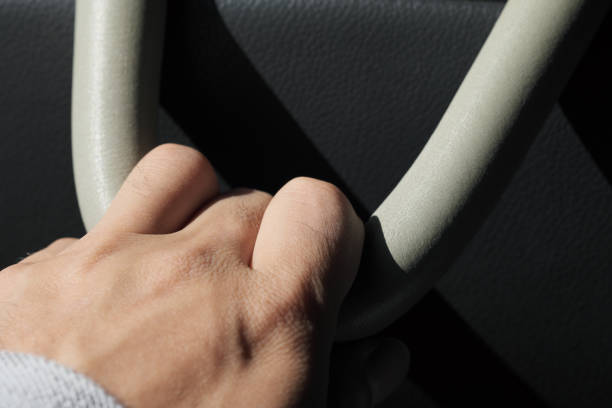 istock A man holding a strap in the back seat of a car 1294780220