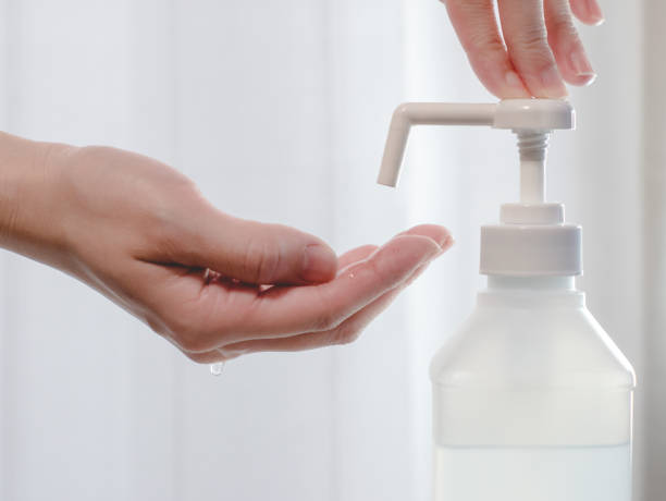 istock Disinfecting hands with alcohol disinfectant spray. 1294784123