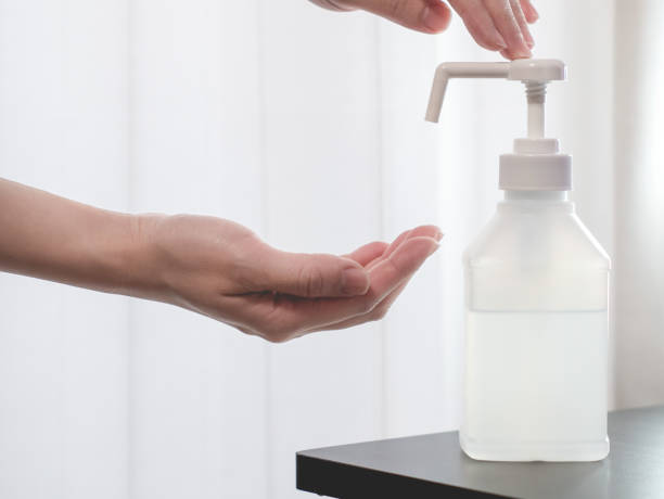 istock Disinfecting hands with alcohol disinfectant spray. 1294784136