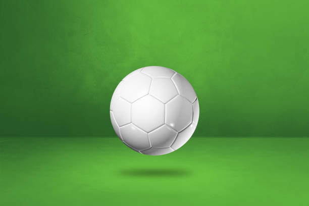 istock White soccer ball on a green studio background 1294784865