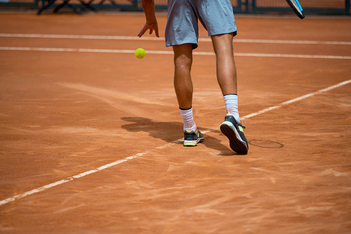 Low section of male tennis player about to serve, Nikon Z7