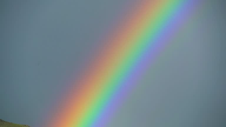 Colorful Rainbow in Vast Treeless Meadow