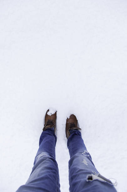 istock Man's feet in snow 1294790814