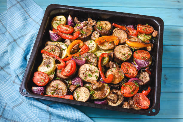 istock Roasted vegetables mix on baking tray on blue wooden background 1294796369