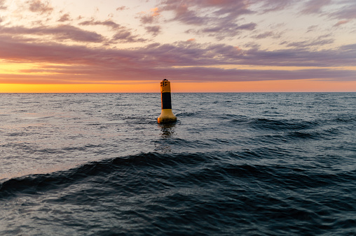 Sunrise in the sea with  floating buoy.