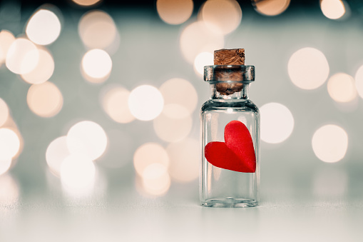 A small bottle with a paper heart. Valentines day concept
