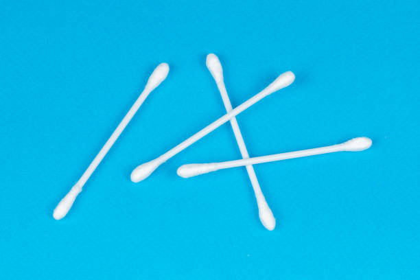 istock Cotton ear stick macro view, isolated on blue 1294797885