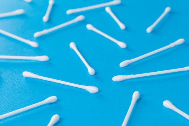 istock Cotton swabs on blue background. Top view ear sticks. 1294797894