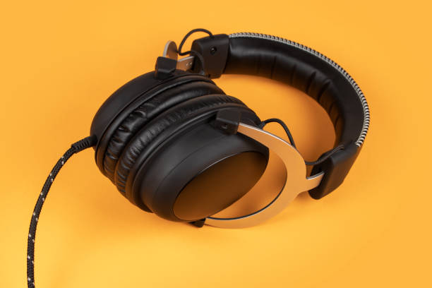 istock Black headphones on yellow background. Music concept 1294800706