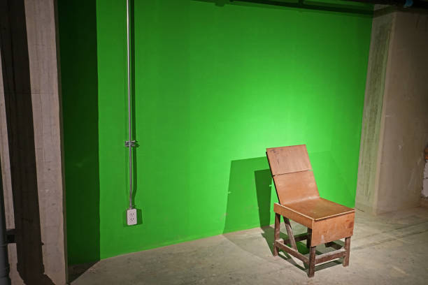 istock Wooden chair in green corner 1294801746