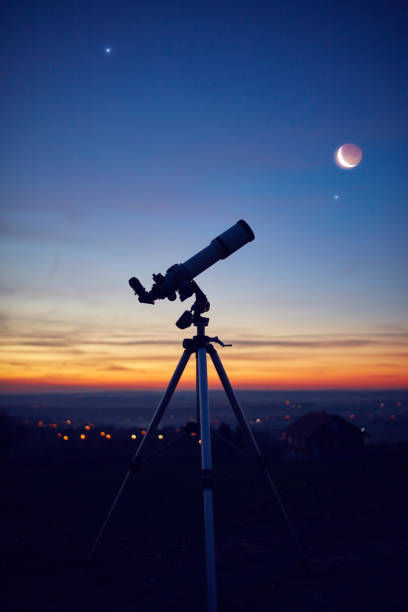 istock Silhouette of a astronomy telescope with twilight sky. 1294803704