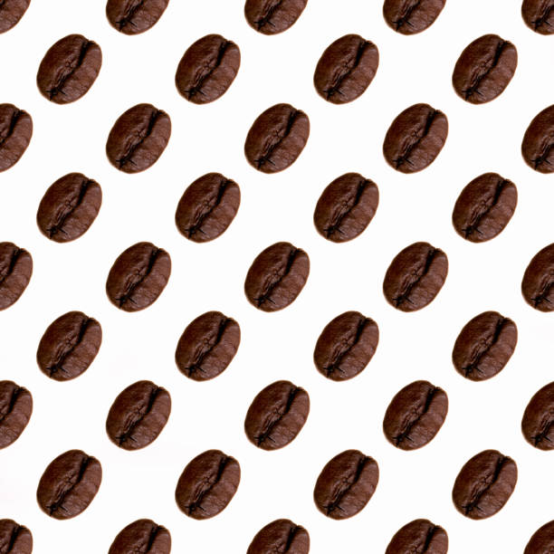 istock Coffee beans laid out in a pattern on a white background, wallpaper, texture, top view 1294804936