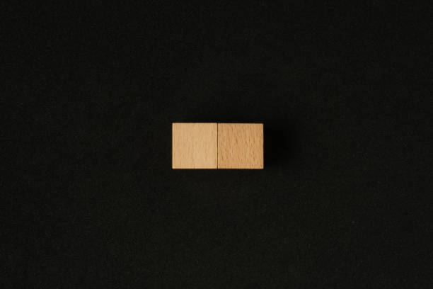 istock Two wooden cube on black background. Flat lay view concept with a copy space 1294804973