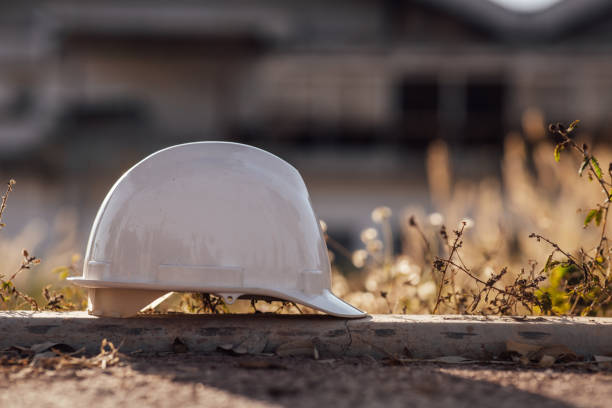 istock White helmet on construction building site. Safety concept 1294806953