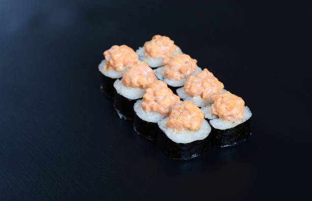 istock Colorful rolls with seafood and rice lie on a dark stone background 1294808775
