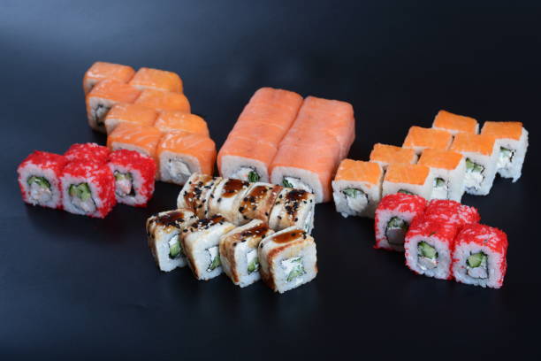 istock Colorful rolls with seafood and rice lie on a dark stone background 1294809008