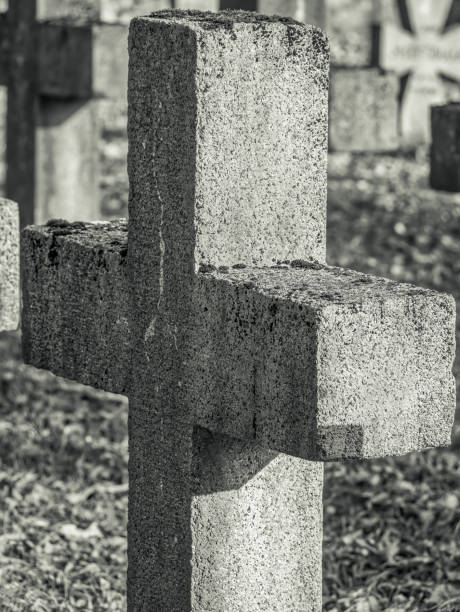 istock Solid stone cross in a cemetery. Close up detail. 1294809814