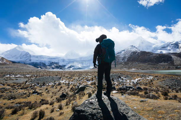 istock Woman backpacker hiking in winter high altitude mountains 1294811766