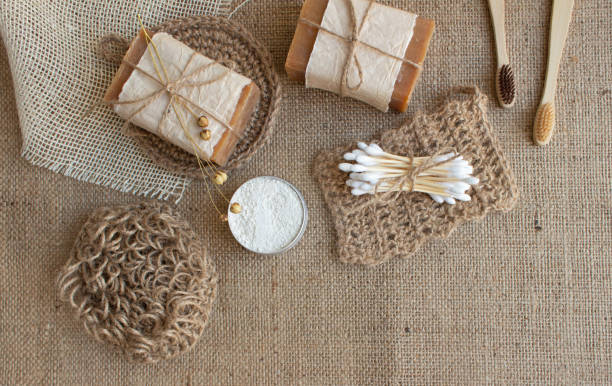 istock Set of different natural bathroom and home spa tools, sustainable zero waste and lifestyle concept. Wooden toothbrushes, bamboo swabs, soap, toothpowder on fabric background with copy space, mockup 1294812694