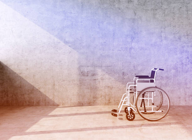 wheelchair in an empty room with window stock photo