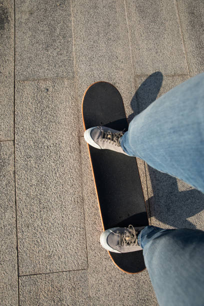 istock Skateboarder skateboarding outdoors on sunny morning 1294815248