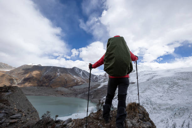 istock Successful woman backpacker hiking in winter mountains 1294817471
