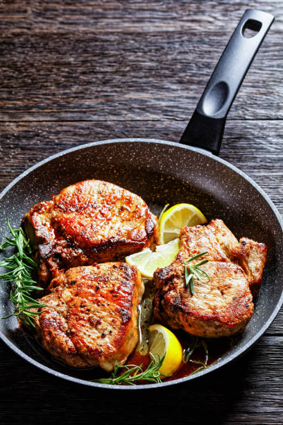 istock roasted pork chops with rosemary sprigs and lemon slices 1294818066
