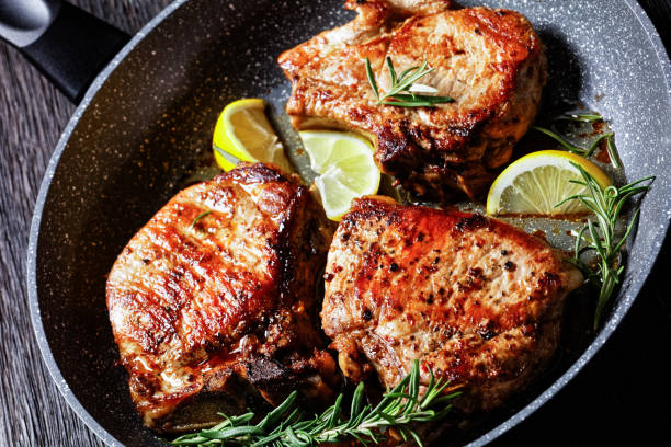 istock roasted pork chops with rosemary sprigs and lemon slices 1294818067