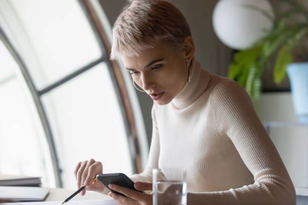 istock Close up confident businesswoman using phone, checking documents 1294818675
