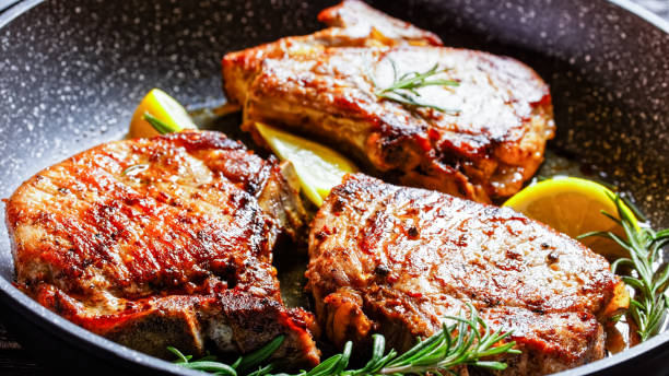 sườn heo nướng với nhánh hương thảo và lát chanh - pork chops hình ảnh sẵn có, bức ảnh & hình ảnh trả phí bản quyền một lần