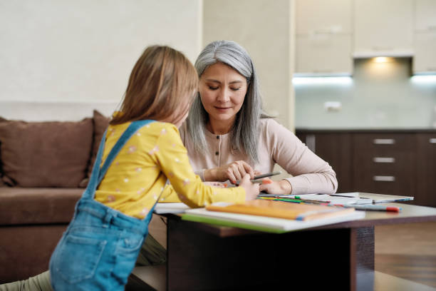 istock Selective focus on babysitter with little girl drawing 1294818788