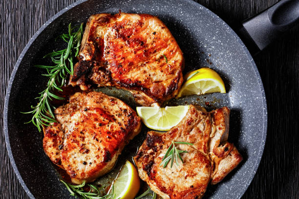 istock roasted pork chops with rosemary sprigs and lemon slices 1294818977