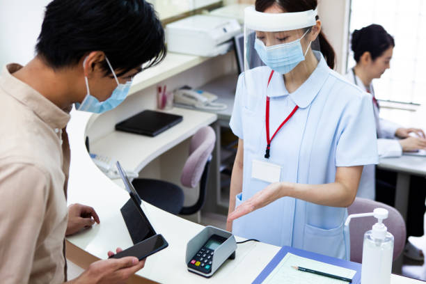 istock A man paying at a hospital using a smartphone 1294819016