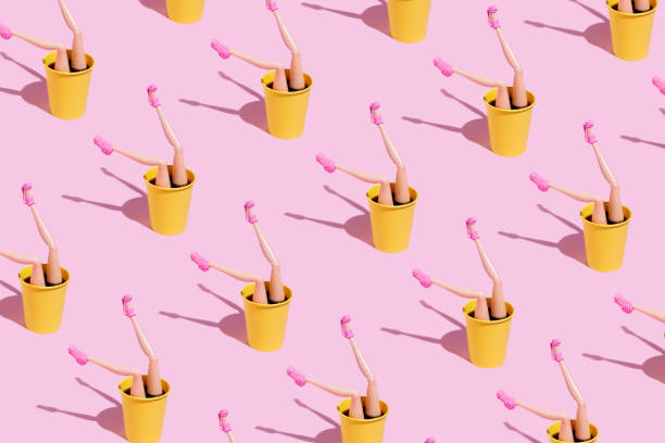 istock Coffee cup pattern with female doll legs and high heels on pink background 1294819073