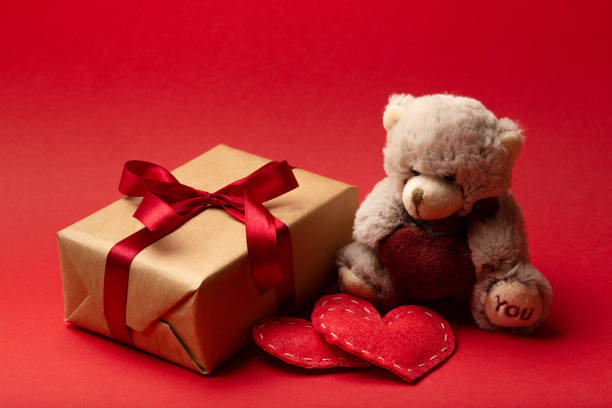 istock Valentines day teddy bear with hearts and gift box. Love concept 1294820261