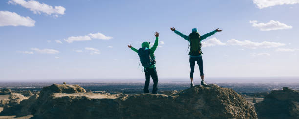 istock Two women backpackers hiking on sand desert 1294821741