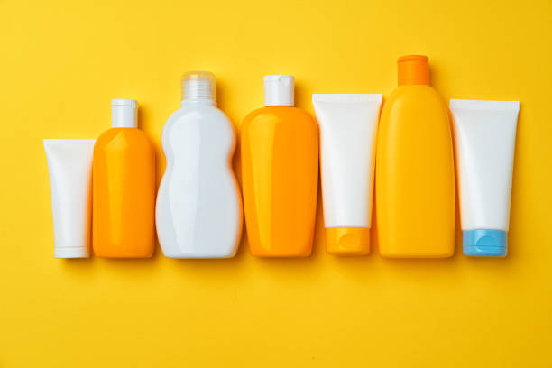 istock Collection of sunscreen cream bottles on yellow background 1294821804