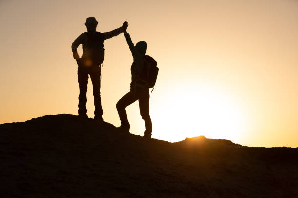 istock Two women backpackers hiking on   desert 1294823278