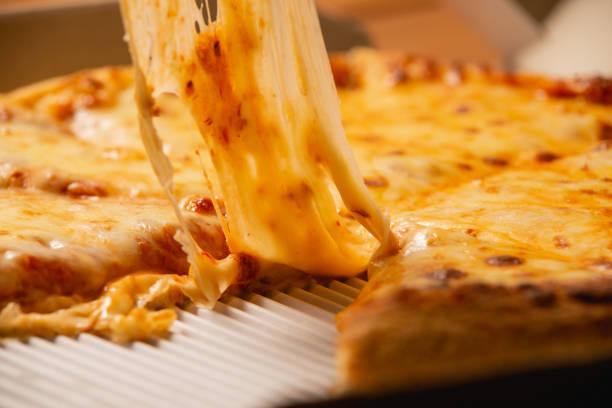 Pizza party. Hand picking slice of pizza.